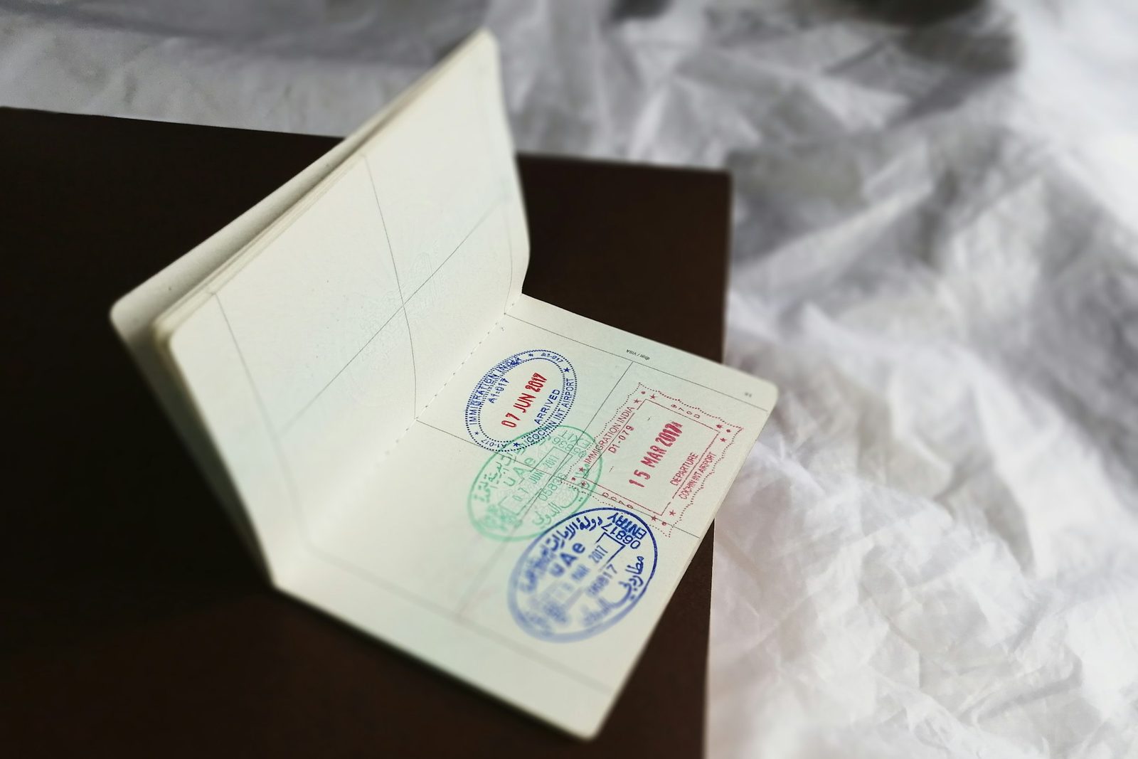 An open passport showing entry stamps on its visa pages